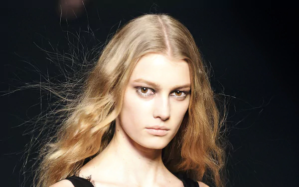 HD desktop wallpaper featuring French model Sigrid Agren with flowing blonde hair against a dark background.