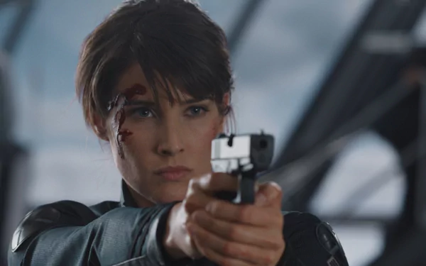 Maria Hill, portrayed by Cobie Smulders, aims her gun with determination in this HD Avengers movie wallpaper, showcasing her fierce character in a dynamic action scene.