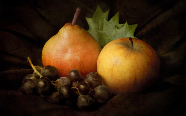 HD PC desktop wallpaper featuring a still life of fruit, including a pear, an apple, dark grapes, and a green leaf on a dark background.