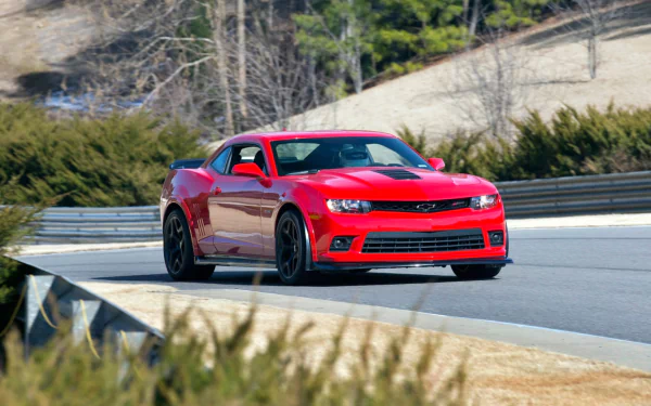 A red Chevrolet Camaro Z28 speeding on a racetrack, captured in high definition as a PC desktop wallpaper and background.