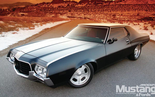 HD PC desktop wallpaper featuring a classic Ford Gran Torino parked on a desert road with rugged hills in the background.