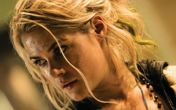 HD desktop wallpaper featuring a close-up of celebrity Rachael Taylor with tousled blonde hair and a contemplative expression.
