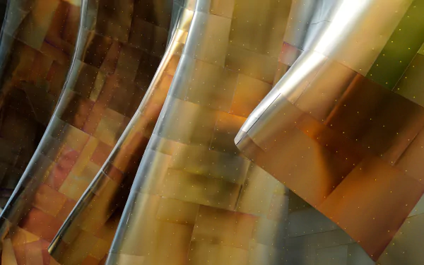 HD PC desktop wallpaper featuring close-up details of reflective, curved metallic architecture with warm bronze and silver tones.