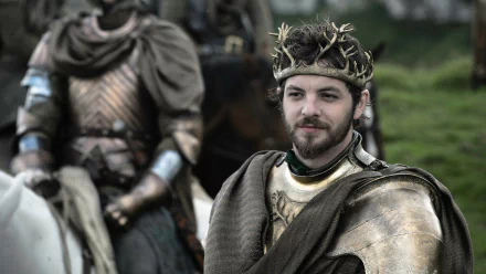 Gethin Anthony as Renly Baratheon from Game of Thrones, adorned in regal armor and a crown, stands confidently in this high-definition desktop wallpaper.