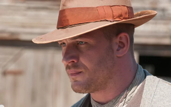 HD desktop wallpaper featuring English actor Tom Hardy in character from the movie Lawless, wearing a wide-brimmed hat and period attire.