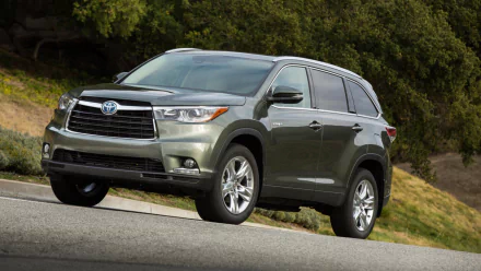 Vehicle: Toyota Highlander Hybrid SUV on a roadside slope with trees; HD PC desktop wallpaper and background.