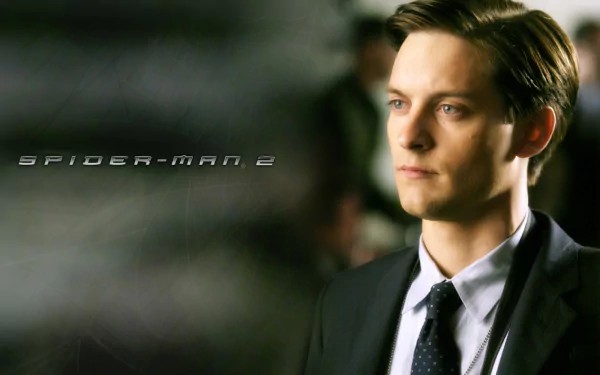 A striking HD wallpaper from Spider-Man 2, featuring Tobey Maguire as Peter Parker, capturing a moment of contemplation against a blurred background.