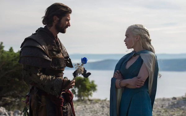 HD desktop wallpaper featuring Michiel Huisman as Daario Naharis and Emilia Clarke as Daenerys Targaryen from the TV show Game of Thrones in a scenic outdoor setting.