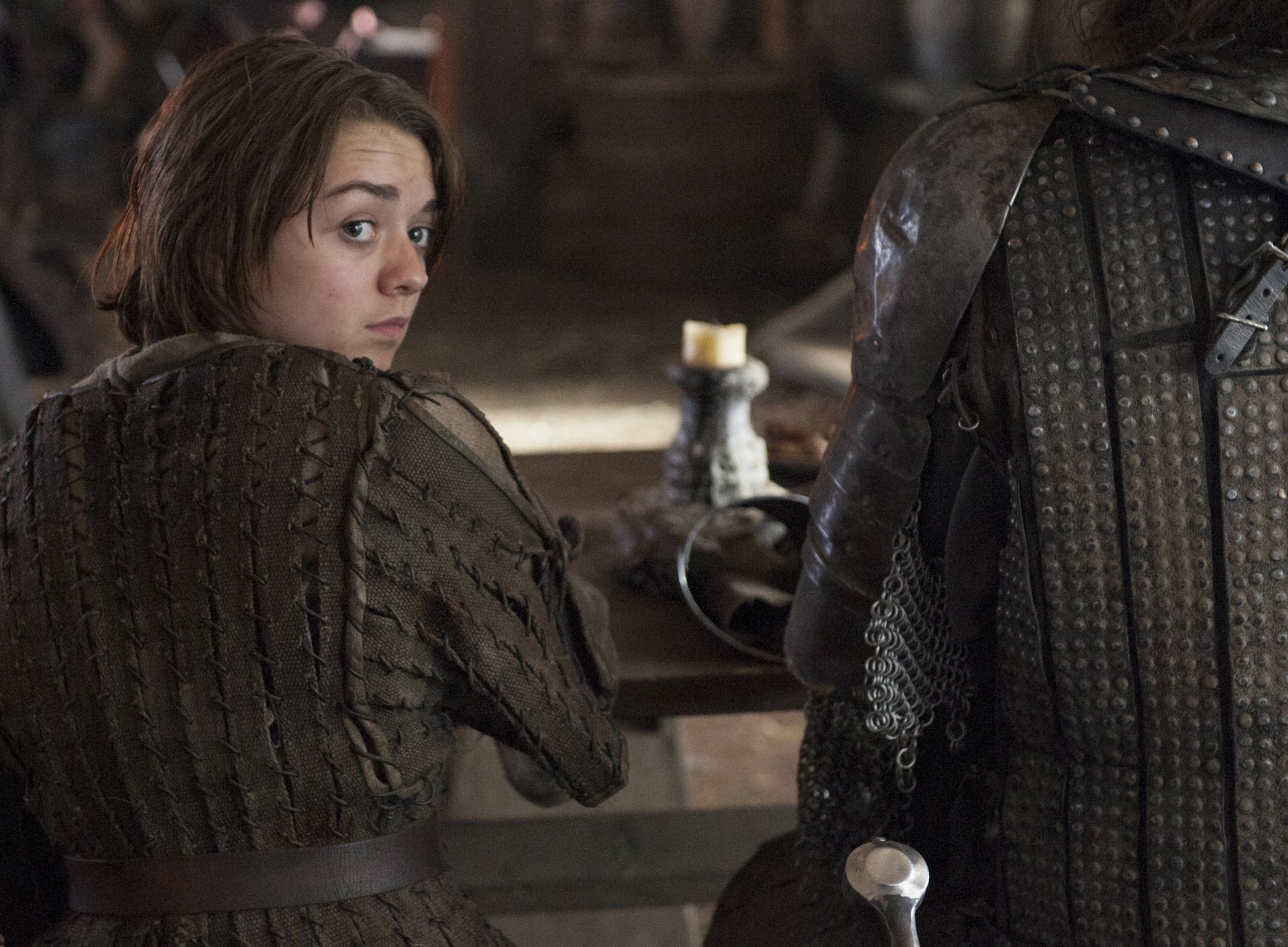 High-resolution 4K Ultra HD wallpaper featuring Maisie Williams as Arya Stark from the TV show Game of Thrones, capturing a tense moment in medieval attire.