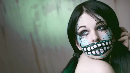 Artistic HD PC desktop wallpaper featuring a woman with a detailed sugar skull face paint against a soft, muted background.
