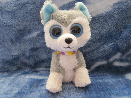 HD desktop wallpaper featuring a man-made Beanie Boos plush toy resembling a gray and white husky with large, blue-rimmed eyes on a soft blue background.
