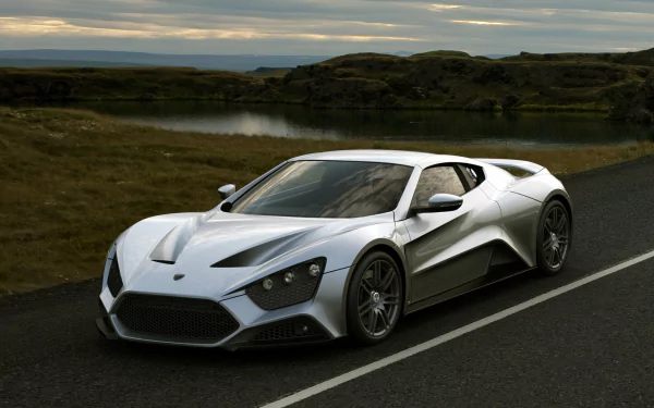 Silver Zenvo ST1 supercar on a country road at dusk — HD PC desktop wallpaper and background featuring the sleek silver vehicle.