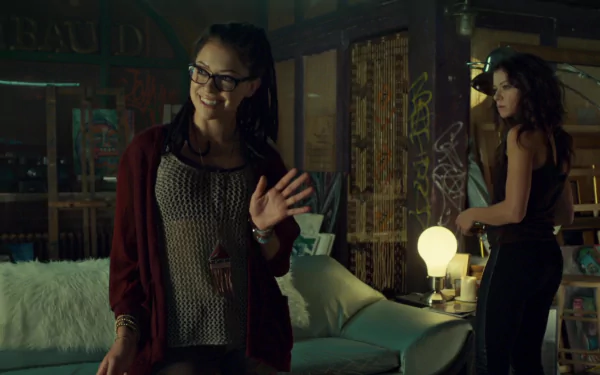 HD PC desktop wallpaper featuring a scene from the TV show Orphan Black with two women in a dimly lit room.