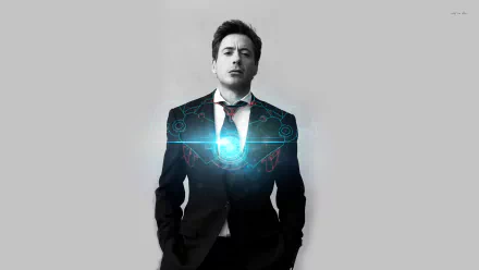 A striking HD wallpaper featuring Robert Downey Jr. in a suit with a glowing arc reactor, embodying his iconic role as Iron Man.