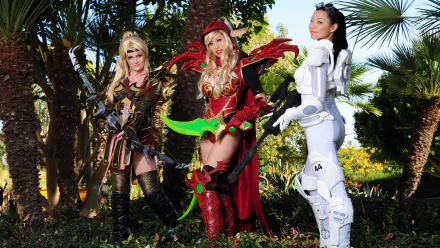 A vibrant 4K Ultra HD wallpaper showcasing three women in striking cosplay, featuring a blood elf character in elaborate armor surrounded by lush greenery.