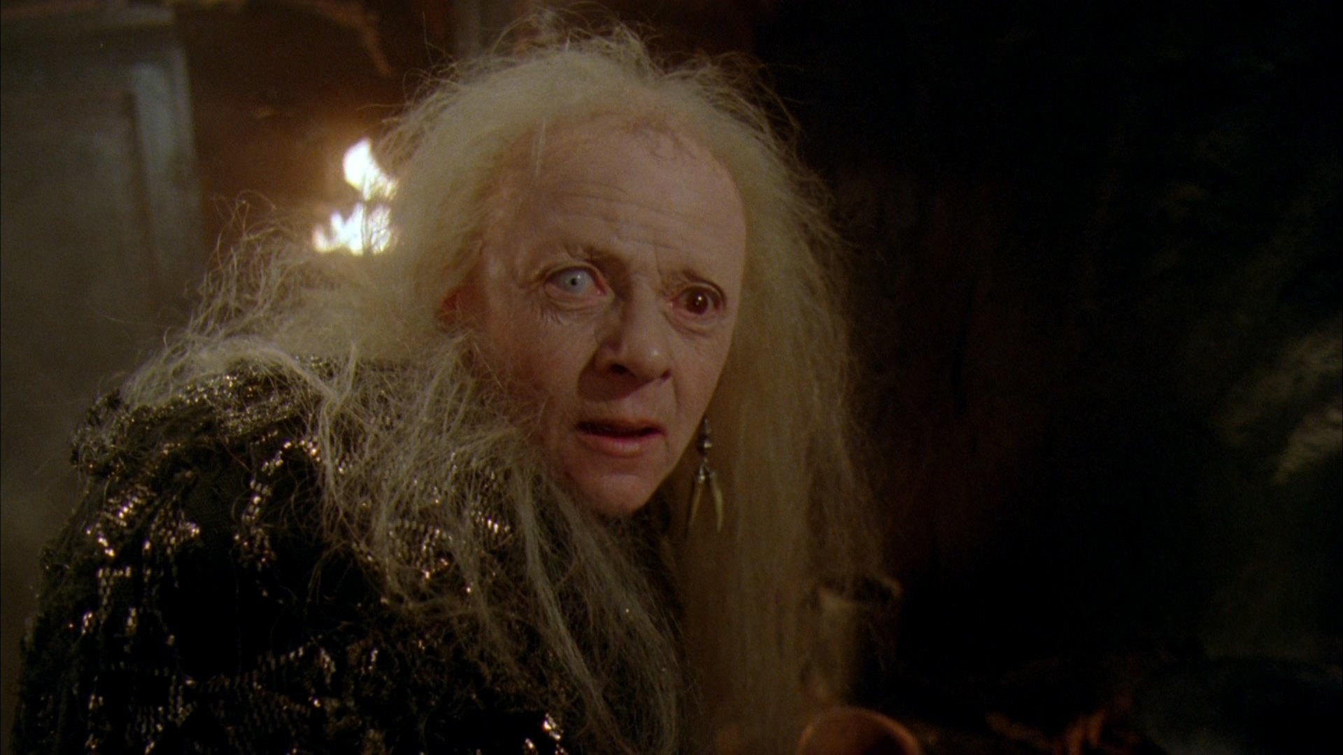 HD PC desktop wallpaper featuring a close-up of a character from the movie Robin Hood: Prince of Thieves, showcasing an intense, aged figure with long white hair.