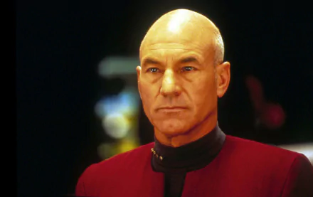 HD desktop wallpaper of actor in Star Trek: The Next Generation uniform, portraying Captain Jean-Luc Picard.
