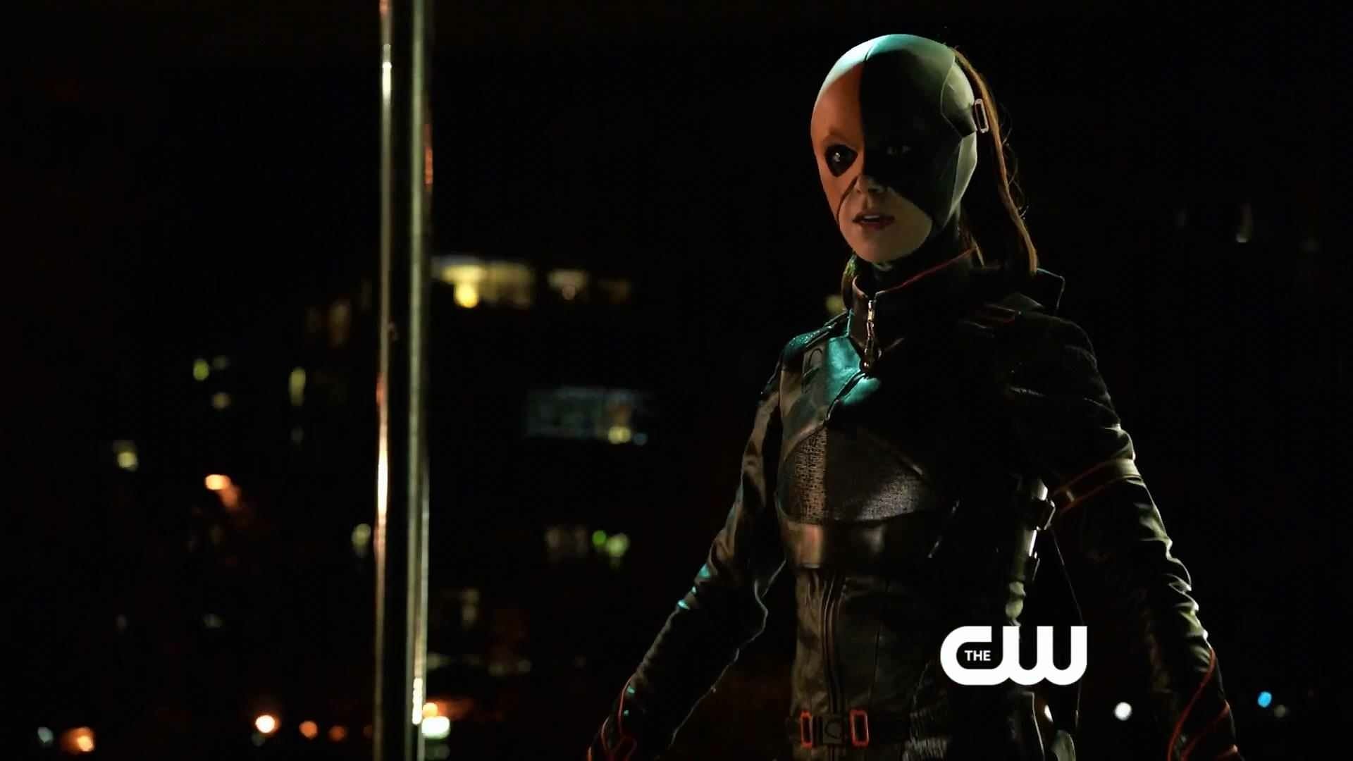 HD desktop wallpaper featuring a character from the TV show Arrow, dressed in dark tactical gear with a half-mask, set against a nighttime urban backdrop.