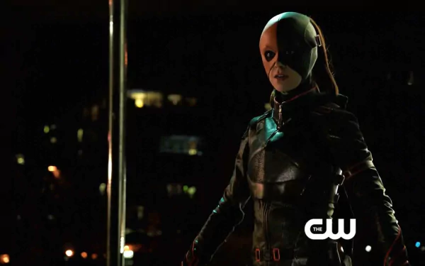 HD desktop wallpaper featuring a character from the TV show Arrow, dressed in dark tactical gear with a half-mask, set against a nighttime urban backdrop.