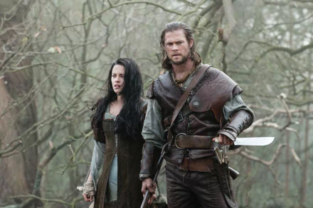 Chris Hemsworth and Kristen Stewart in a scene from the movie Snow White and the Huntsman, featured in an HD PC desktop wallpaper and background.