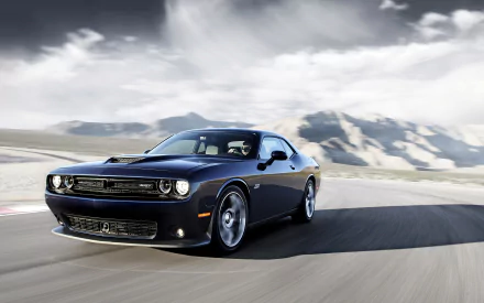 A high-definition desktop wallpaper featuring a sleek Dodge Challenger SRT Hellcat speeding through a scenic mountain backdrop.