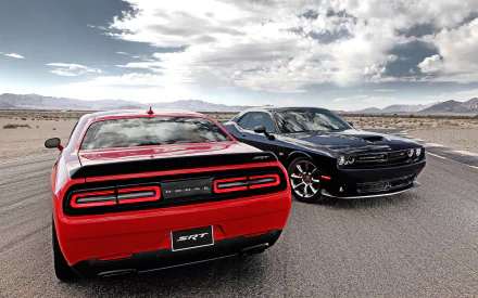 HD desktop wallpaper featuring a red and a black Dodge Challenger SRT Hellcat parked on an open road under a partly cloudy sky.
