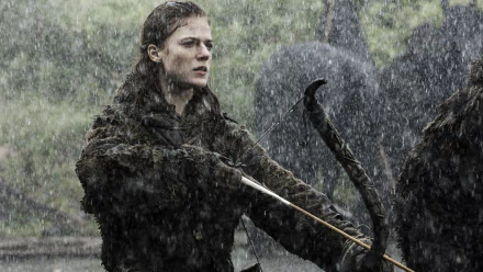 Ygritte, portrayed by Rose Leslie in Game of Thrones, stands determined in the rain, wielding a bow and arrow. A striking 4K Ultra HD wallpaper for fans of the series.