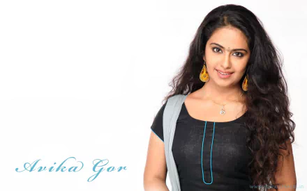 HD PC desktop wallpaper featuring Avika Gor, a woman with long dark hair, wearing a black outfit and yellow earrings, smiling against a white background.