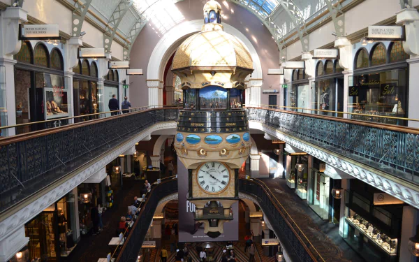 Interior view of the Queen Victoria Building in Sydney, Australia, showcasing its historic architecture, central clock, and shoppers in a vibrant, well-lit space.