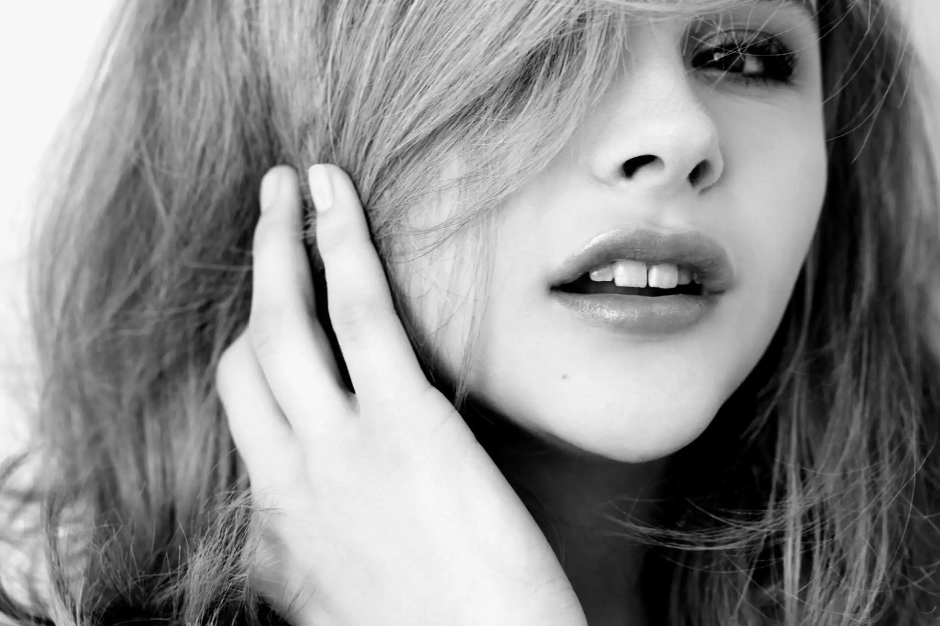 Black and white HD desktop wallpaper featuring a close-up portrait of celebrity Chloë Grace Moretz with tousled hair and a soft expression.