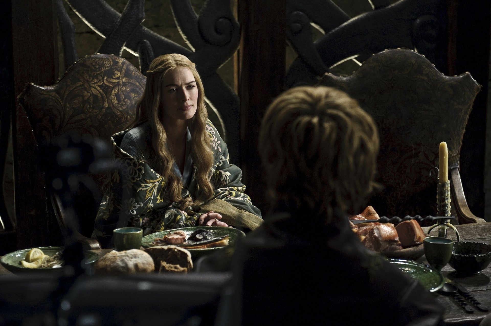 HD desktop wallpaper featuring Lena Headey as Cersei Lannister from the TV show Game of Thrones, seated at a dimly lit banquet table.