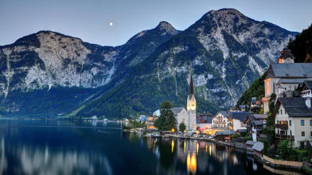 A serene view of Hallstatt, Austria, showcasing a tranquil lake, charming buildings, and majestic mountains, captured in a vibrant HD desktop wallpaper.