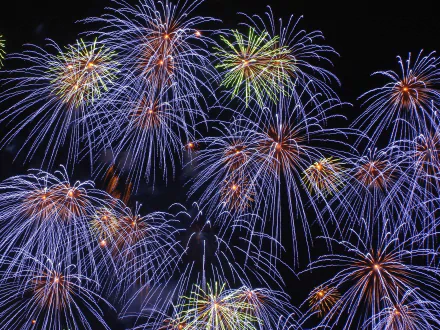 A vibrant 4th of July fireworks display bursting in a night sky, serving as an HD desktop wallpaper background.