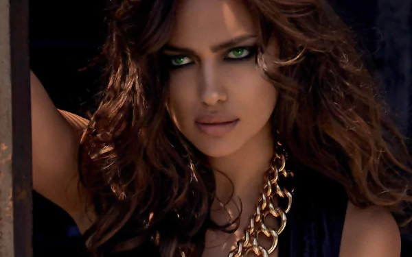 A stunning brunette model with striking green eyes poses confidently, showcasing her beauty. This high-definition wallpaper features the captivating Irina Shayk.