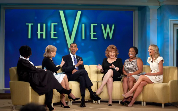 HD desktop wallpaper of The View show with people seated in front of the show's logo, engaging in a discussion.