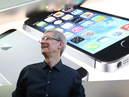 HD wallpaper featuring a man smiling with an iPhone illustration in the background.