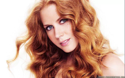 HD desktop wallpaper featuring a portrait of a woman with long wavy red hair and a gentle gaze against a white background.