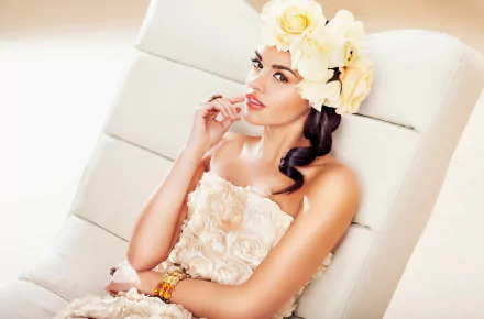 HD PC desktop wallpaper featuring model Anita Sikorska in a floral dress with matching large flower headpiece, posing elegantly against a soft white background.