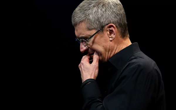 HD desktop wallpaper featuring a contemplative man in black attire against a dark background.