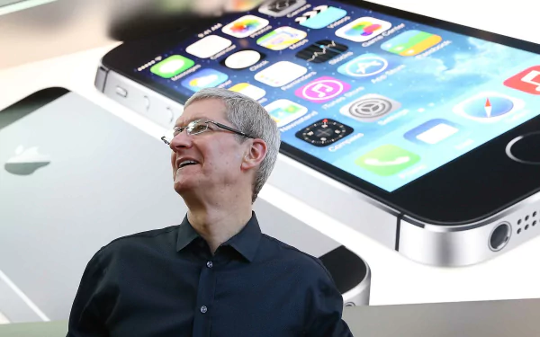 HD wallpaper featuring a man smiling with an iPhone illustration in the background.