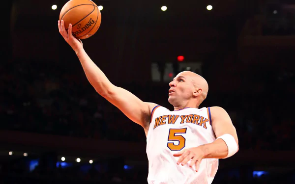 HD wallpaper of a basketball player in action on the court, dressed in a New York jersey reaching for a layup.