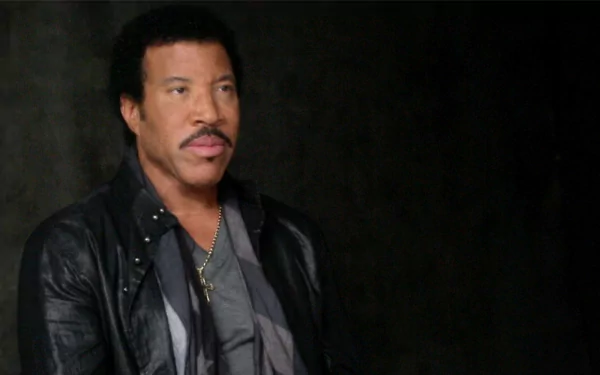HD wallpaper of a man resembling Lionel Richie in a leather jacket against a dark background.