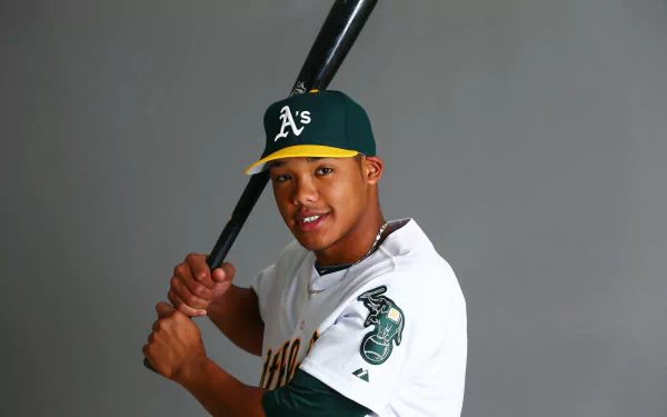 HD wallpaper featuring a player in an Oakland Athletics uniform holding a baseball bat, set against a grey background.