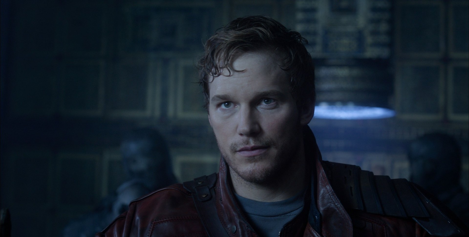 HD desktop wallpaper featuring Chris Pratt as Peter Quill from Guardians of the Galaxy, set against a moody, dimly-lit backdrop.