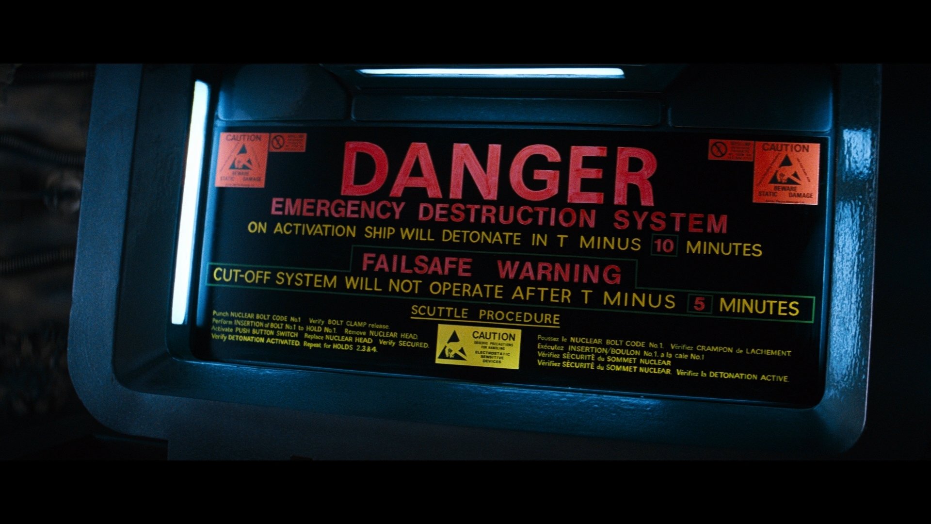 HD PC desktop wallpaper featuring a movie-themed alien emergency destruction warning panel with bold red and yellow caution text on a dark background.