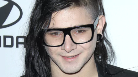 HD desktop wallpaper featuring Skrillex, known for his influential music, showcases his unique style with long hair and stylish glasses.