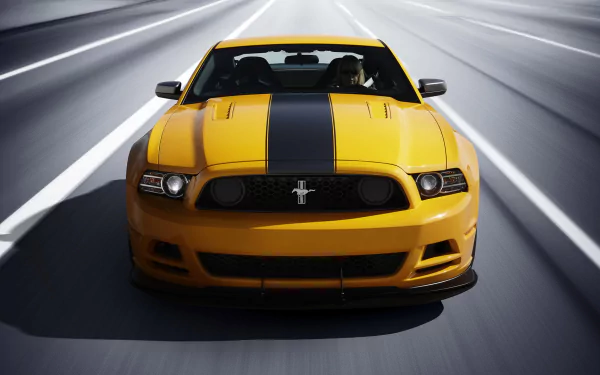 HD desktop wallpaper showcasing a yellow Ford Mustang Shelby with black racing stripes speeding down a multi-lane highway.