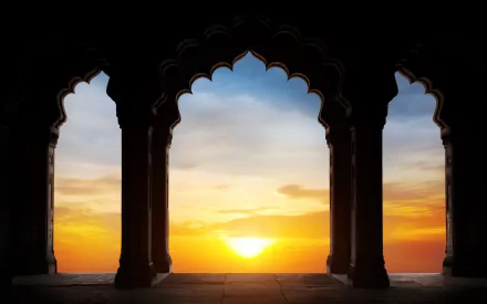 HD desktop wallpaper featuring a serene sunset framed by ornate arches of a religious temple, blending tranquility and architectural beauty.