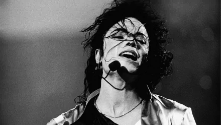 Black and white HD desktop wallpaper depicting musician Michael Jackson passionately performing on stage with a headset microphone.