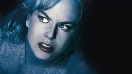 HD PC desktop wallpaper for the movie The Invasion: close-up of a pale, intense woman with blue-tinted hair and a piercing gaze against a dark background.